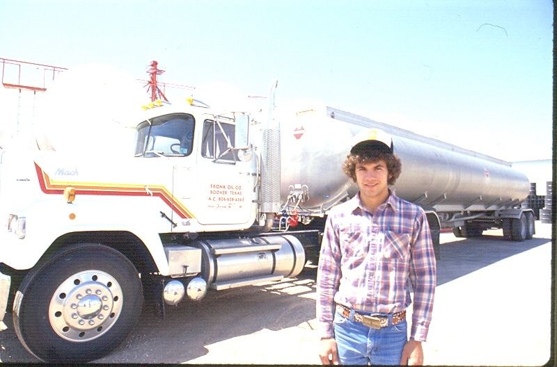 Person standing beside Fronk Oil tanker truck