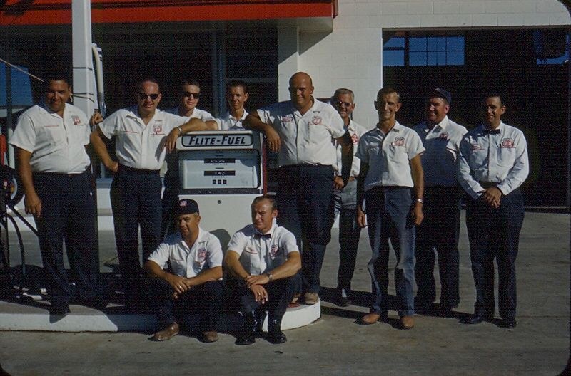 Historical team photograph outside a Fronk Oil building